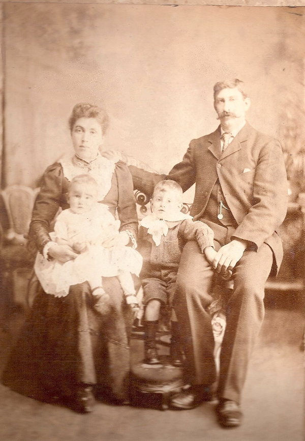 Formal portrait of Charles Ringham and Family: Caroline, Lawrence and Horace.